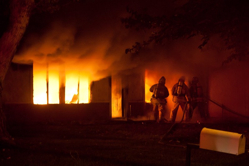Firefighters fighting a house fire.
